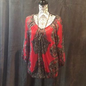 Sheer red blouse with black camisole